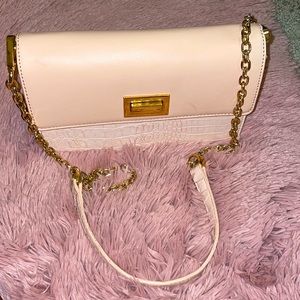 Pink leather BEBE crossbody purse with gold chain.